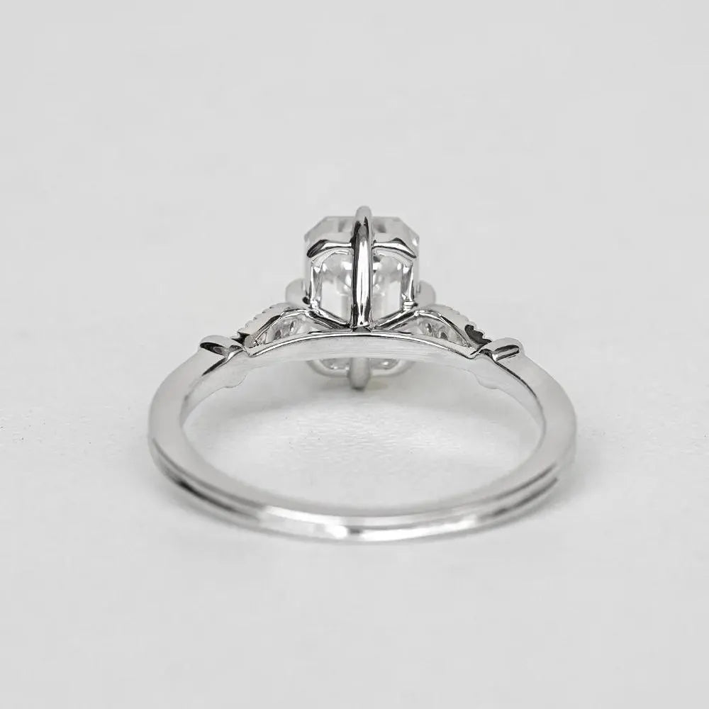 Elegant Emerald Cut Solitaire Engagement Ring In White Gold With Dainty Accent Stones. A Timeless Moissanite Wedding Or Promise Ring For Her