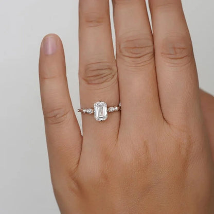 Elegant Emerald Cut Solitaire Engagement Ring In White Gold With Dainty Accent Stones. A Timeless Moissanite Wedding Or Promise Ring For Her